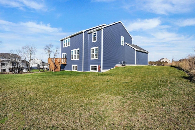 view of side of property with a yard and a deck