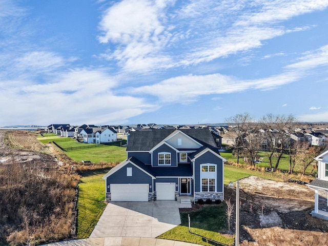 view of front of property with a garage and a front lawn