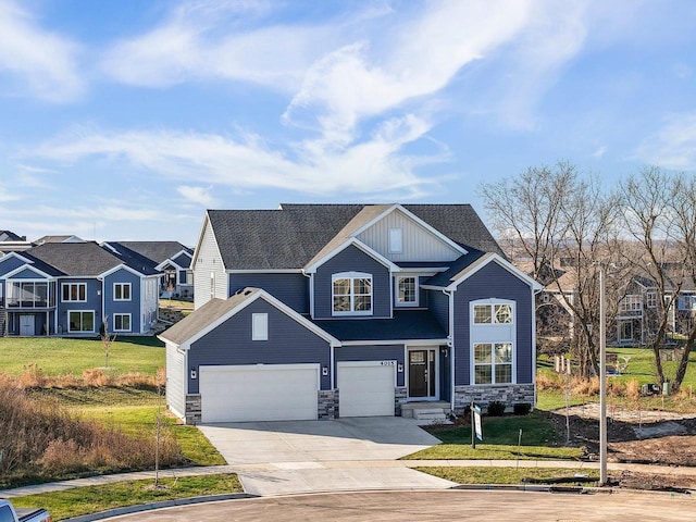 craftsman-style home featuring a garage and a front lawn