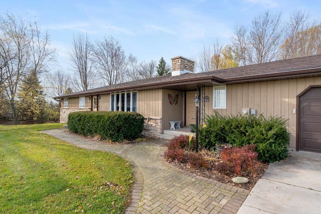 single story home with a front lawn and a garage