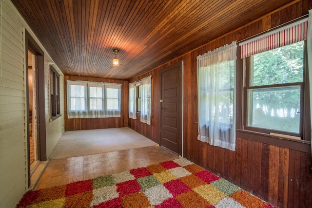 unfurnished sunroom with a wealth of natural light and wood ceiling