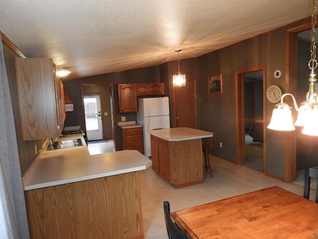 kitchen with pendant lighting, vaulted ceiling, a textured ceiling, a notable chandelier, and white fridge