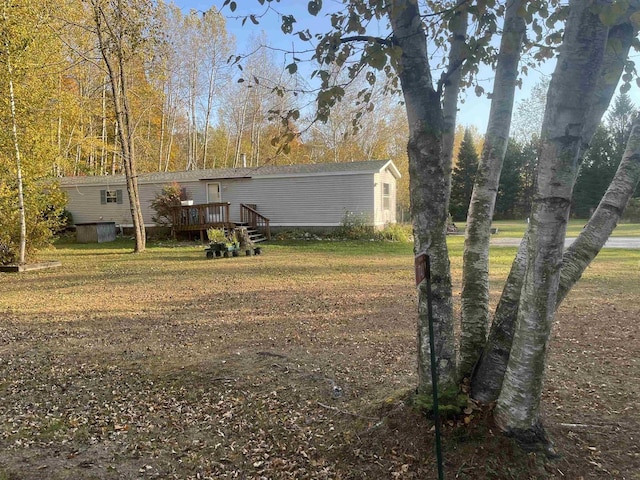 view of yard featuring a wooden deck