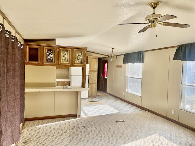 17401 Wildflower Ln, Townsend, WI 54175 - kitchen with vaulted ceiling, light carpet, a ceiling fan, a peninsula, and light countertops