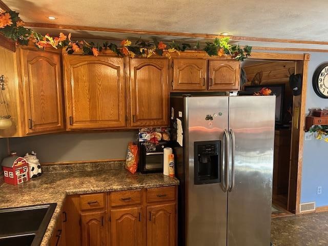 kitchen featuring stainless steel fridge with ice dispenser and ornamental molding