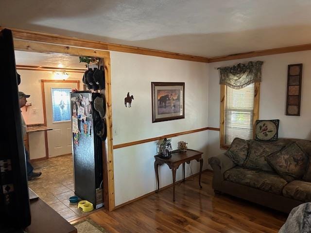 living room featuring light wood-type flooring and crown molding