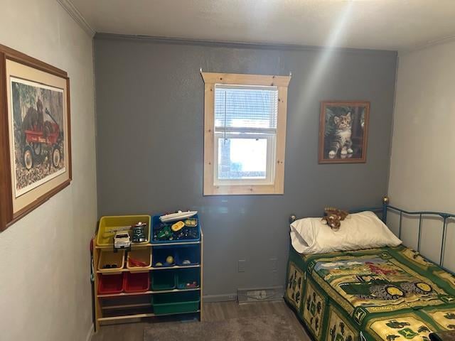 bedroom featuring dark carpet and ornamental molding