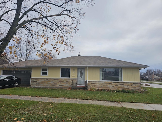 ranch-style home with a garage and a front lawn