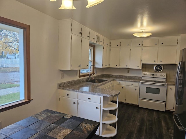 kitchen featuring white cabinets, white range with electric cooktop, a wealth of natural light, and sink