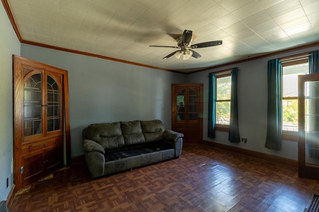 living room featuring dark parquet flooring, ceiling fan, and ornamental molding