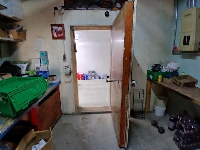 miscellaneous room with concrete flooring and electric panel