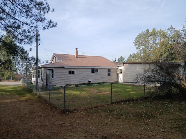 back of property featuring a lawn