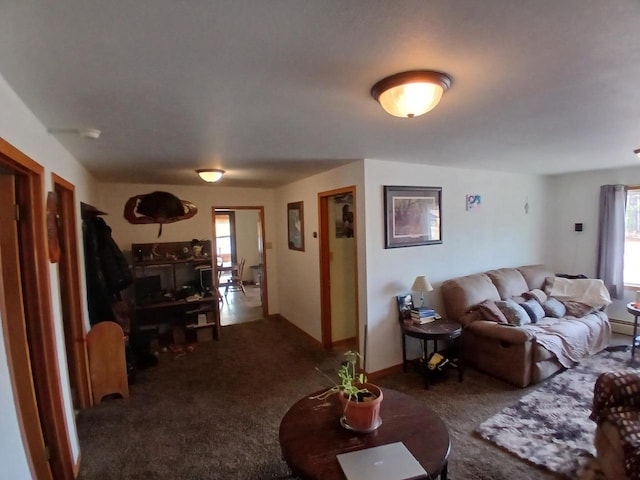 living room with dark colored carpet