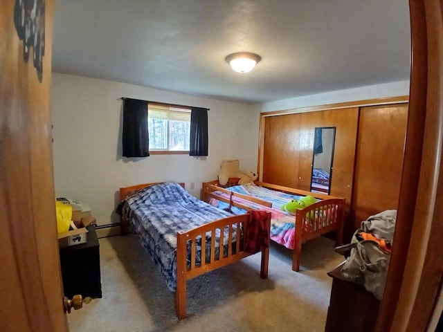 bedroom with light carpet and a baseboard heating unit