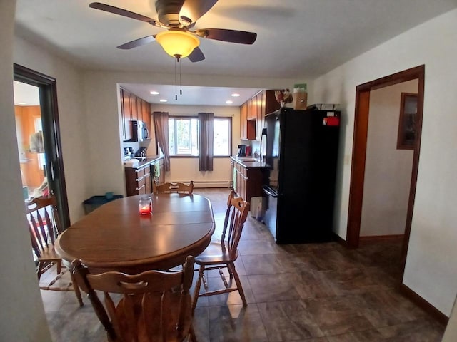 dining area with a baseboard radiator and ceiling fan