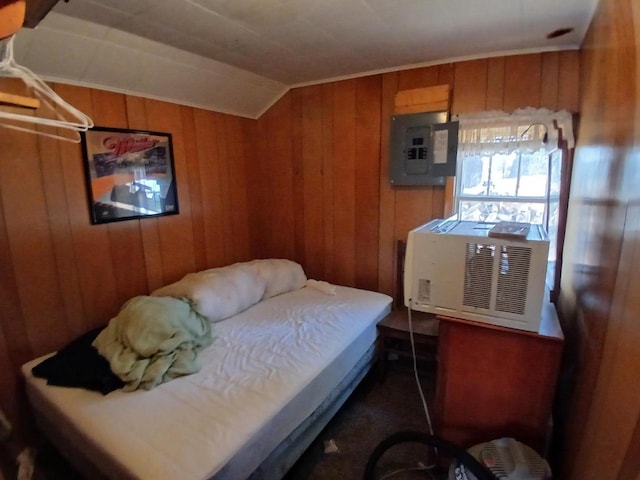 bedroom with lofted ceiling, electric panel, cooling unit, and wooden walls