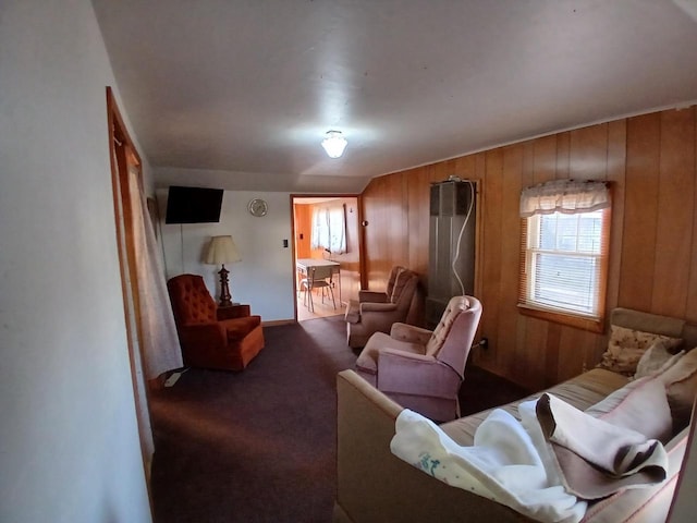 carpeted living room with wooden walls