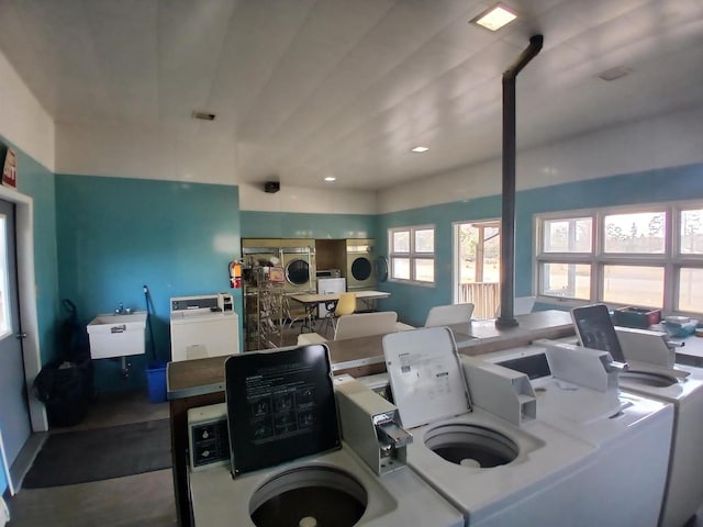 interior space featuring washer and dryer, concrete floors, and sink