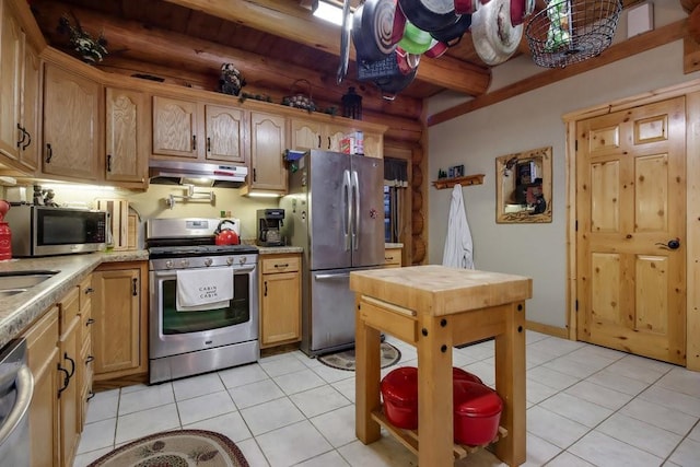 kitchen featuring beamed ceiling, light tile patterned floors, and stainless steel appliances