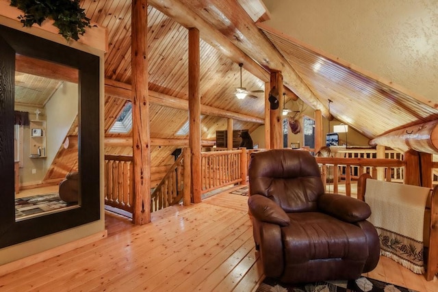 sitting room featuring wooden ceiling, light hardwood / wood-style flooring, and lofted ceiling with beams