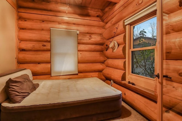 living area featuring wooden ceiling and log walls