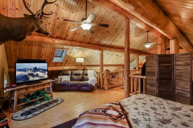 living room with ceiling fan, vaulted ceiling with skylight, wooden ceiling, and hardwood / wood-style flooring