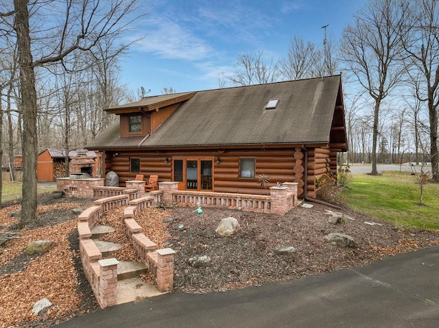 log home featuring covered porch