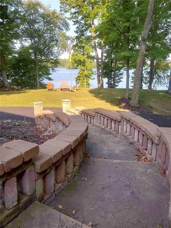 view of home's community featuring a yard and a water view