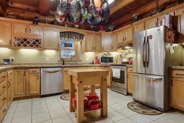 kitchen with wooden ceiling, sink, light tile patterned floors, appliances with stainless steel finishes, and beamed ceiling