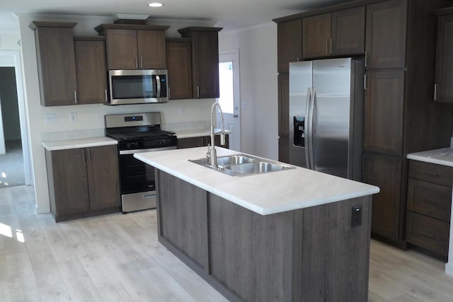 S13041 Shifflet Rd Unit 128, Spring Green, WI 53588 - kitchen with appliances with stainless steel finishes, a sink, light wood-style floors, light countertops, and a center island with sink
