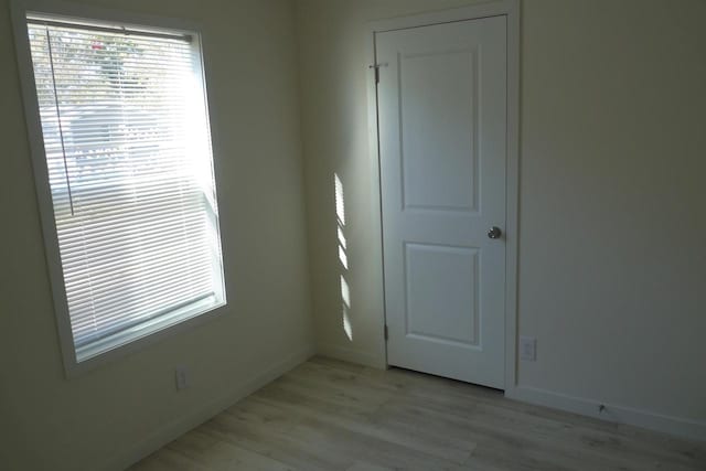 empty room with light hardwood / wood-style floors