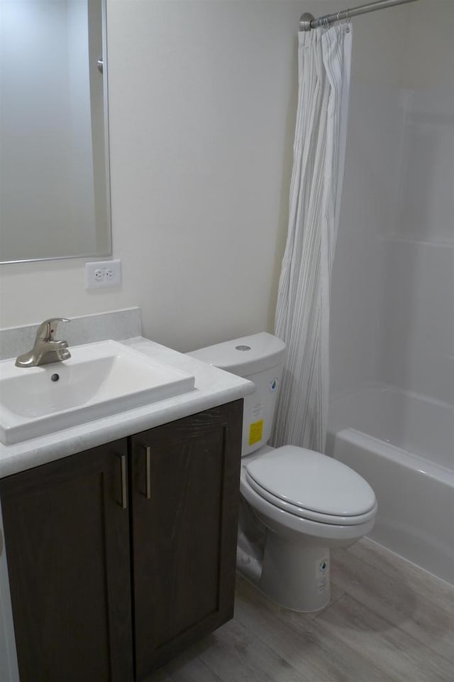 S13041 Shifflet Rd Unit 128, Spring Green, WI 53588 - full bathroom with vanity, wood finished floors, toilet, and shower / tub combo