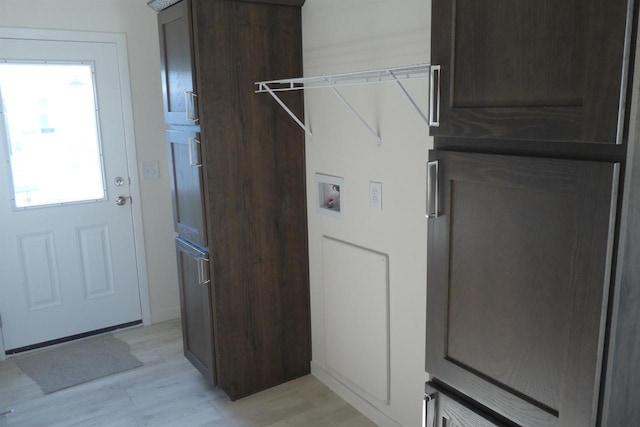 clothes washing area featuring washer hookup and light hardwood / wood-style floors