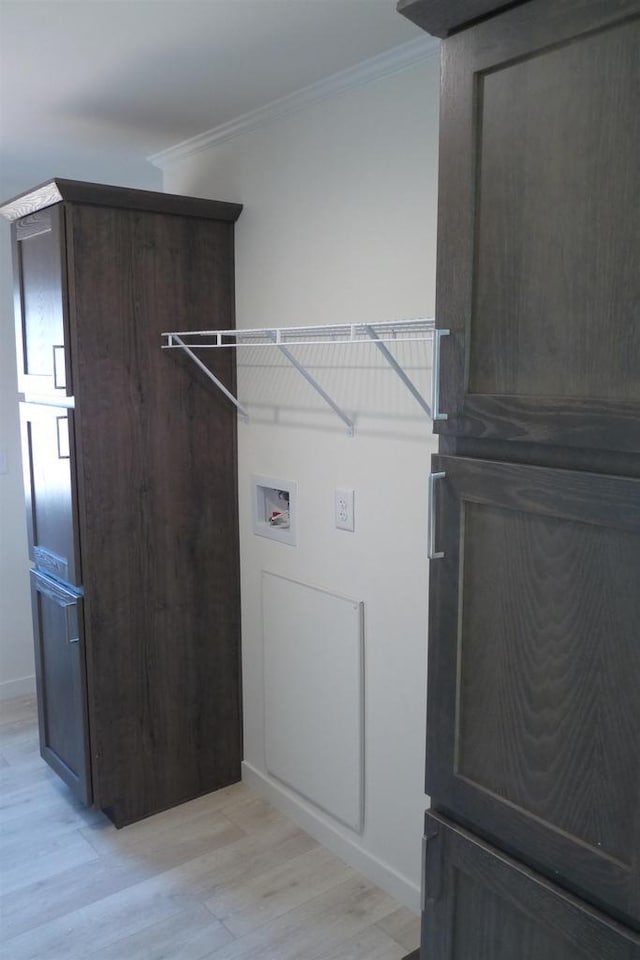 S13041 Shifflet Rd Unit 128, Spring Green, WI 53588 - washroom featuring ornamental molding, washer hookup, and light wood-type flooring