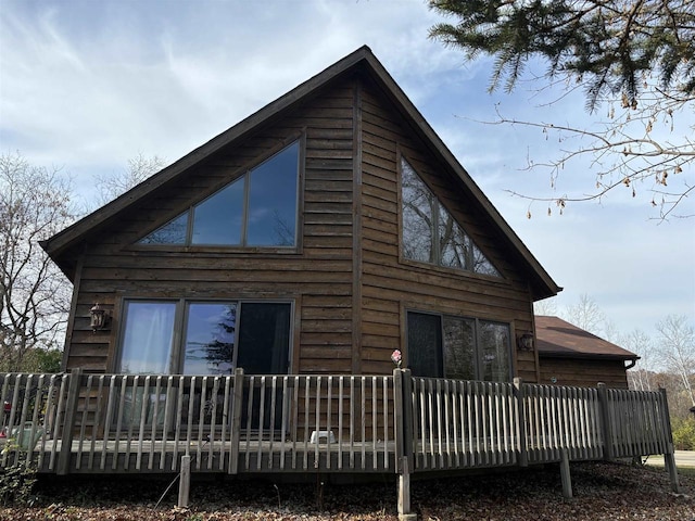 view of home's exterior with a wooden deck