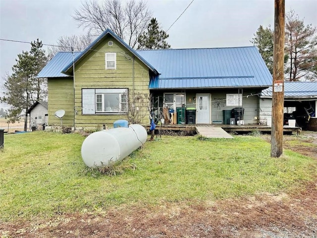 rear view of property with a yard