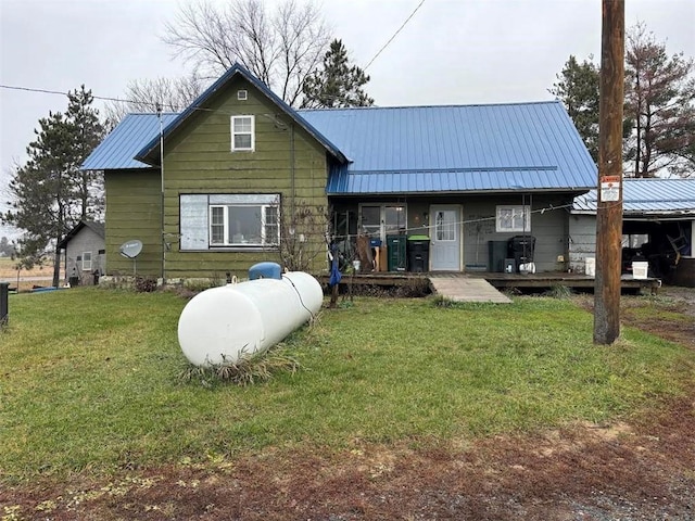 rear view of property featuring a yard