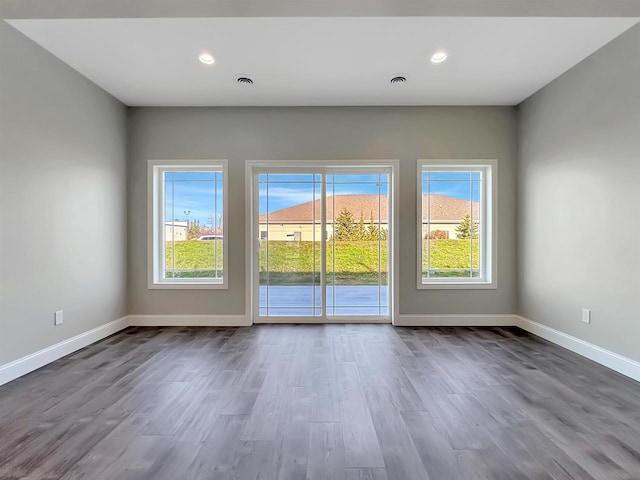 spare room featuring dark wood-type flooring