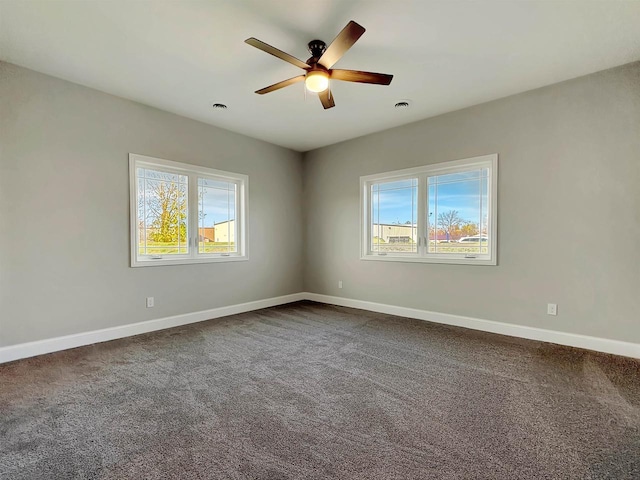 carpeted spare room featuring ceiling fan