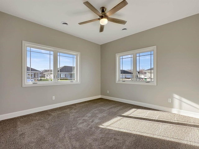 spare room with ceiling fan, carpet floors, and a healthy amount of sunlight