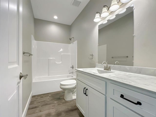 full bathroom with wood-type flooring, vanity, toilet, and tub / shower combination