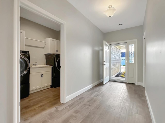 entryway featuring light hardwood / wood-style flooring and washer / dryer