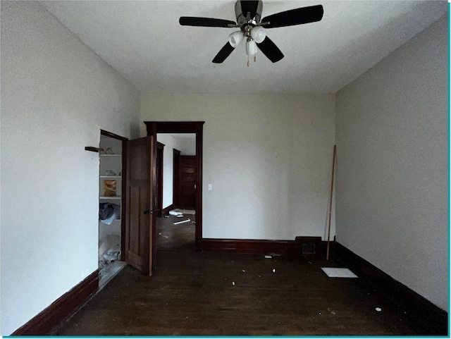 unfurnished room featuring ceiling fan and dark hardwood / wood-style floors