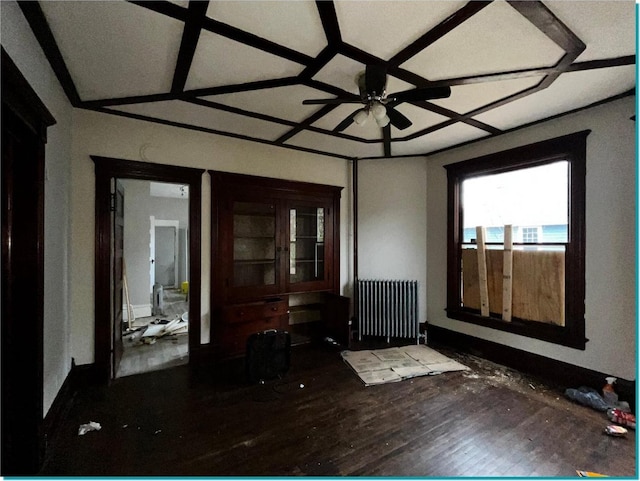 interior space featuring ceiling fan, wood-type flooring, radiator heating unit, and coffered ceiling