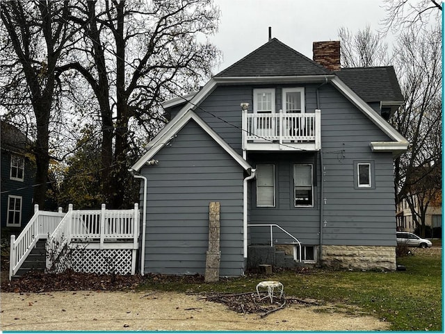 rear view of house featuring a balcony