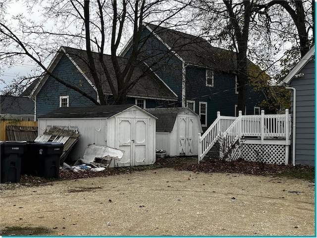 exterior space with a wooden deck and a storage shed