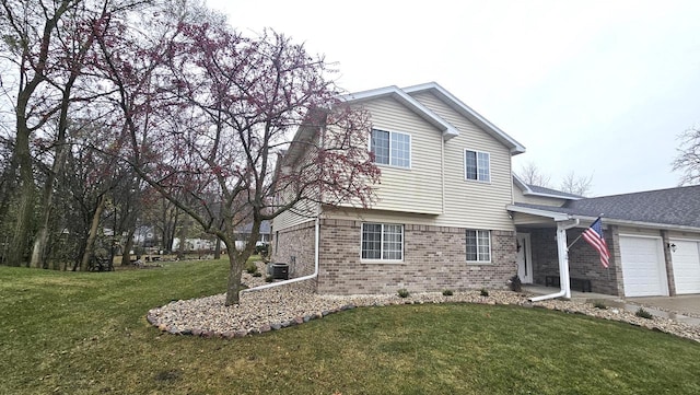 view of front of home with cooling unit, a front lawn, and a garage