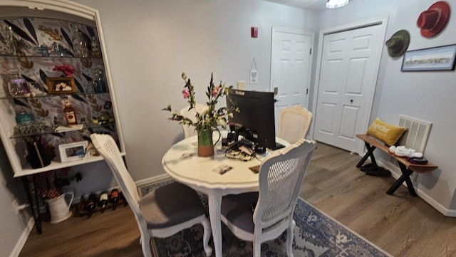 dining space with dark wood-type flooring