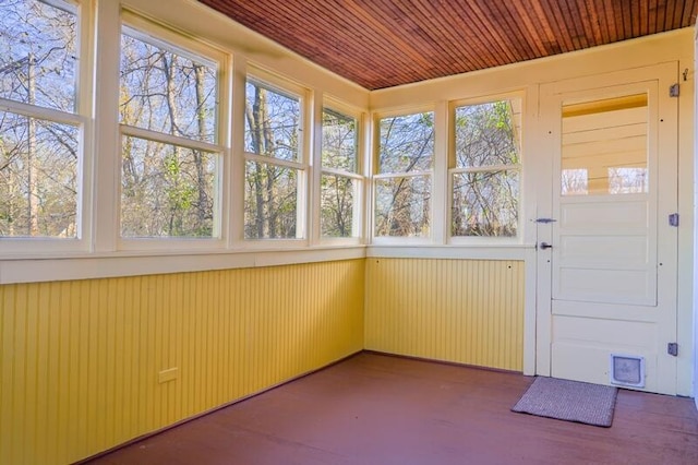 unfurnished sunroom with wooden ceiling