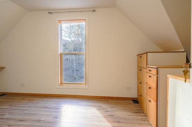 bonus room featuring light wood-type flooring and lofted ceiling